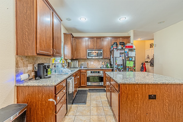 kitchen with tasteful backsplash, sink, stainless steel appliances, light stone countertops, and light tile patterned floors