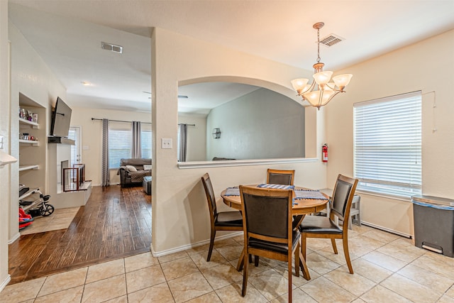 dining area with a notable chandelier and light hardwood / wood-style flooring