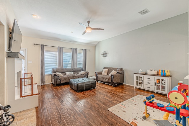 living room featuring ceiling fan and hardwood / wood-style floors