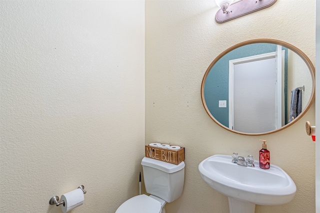 bathroom featuring sink and toilet