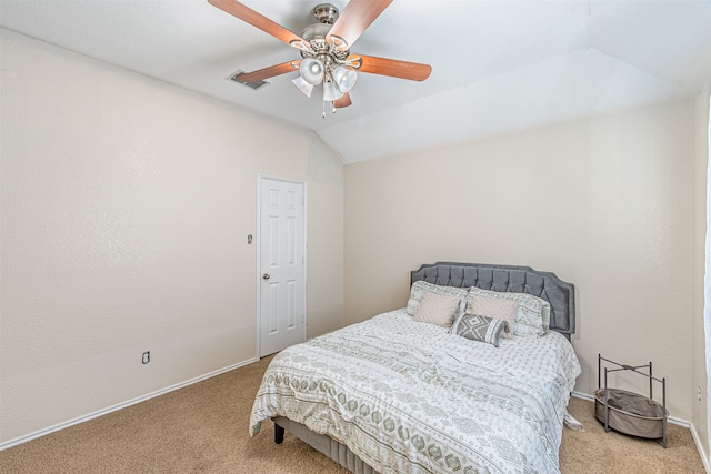 carpeted bedroom with ceiling fan and vaulted ceiling