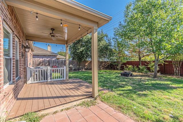 exterior space featuring a deck and ceiling fan