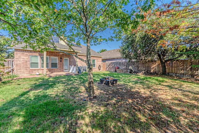 view of yard with a patio and a fire pit