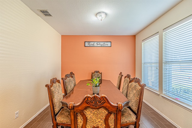 dining space with dark hardwood / wood-style flooring