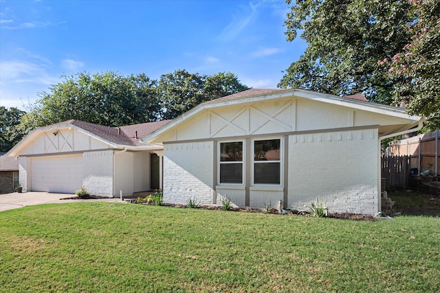 single story home featuring a front yard and a garage