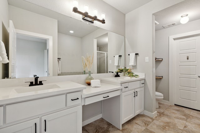 bathroom with vanity, toilet, and a shower with door