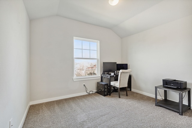 office with lofted ceiling and carpet flooring