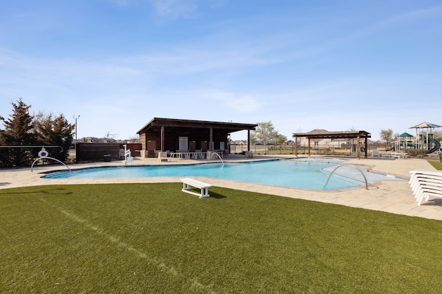 view of pool featuring a yard and a patio area