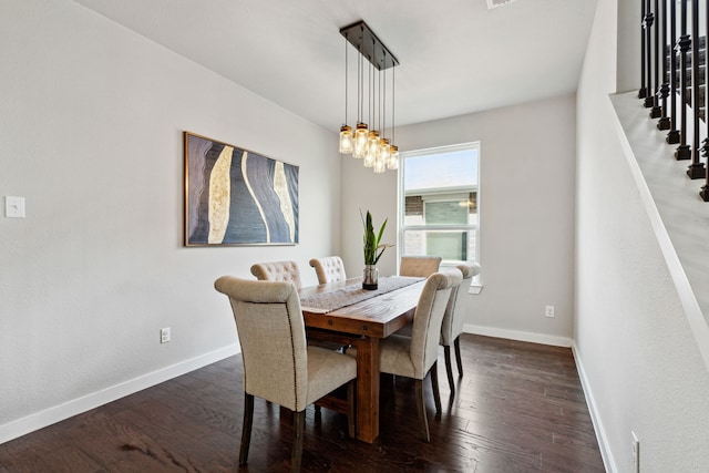 dining space featuring dark hardwood / wood-style floors and a chandelier