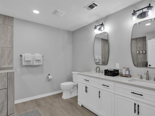 bathroom with vanity, toilet, and hardwood / wood-style flooring