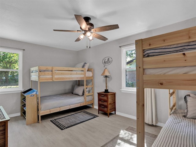 bedroom with light wood-type flooring and ceiling fan