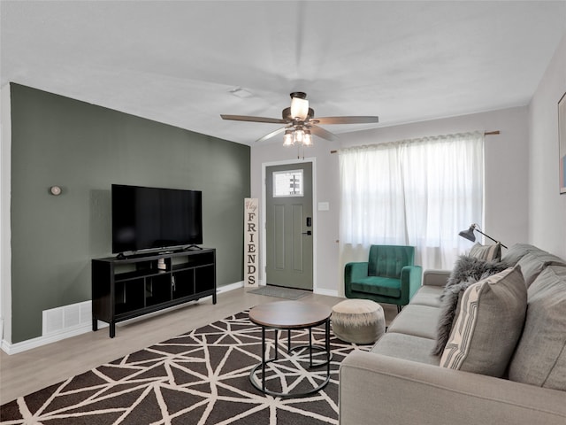 living room with ceiling fan and hardwood / wood-style flooring