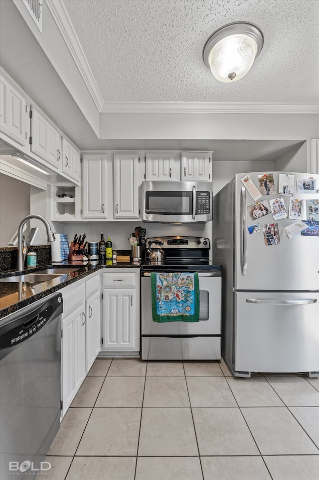 kitchen with white cabinets, appliances with stainless steel finishes, crown molding, and sink