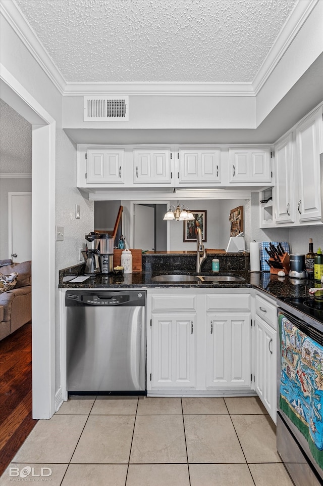 kitchen featuring white cabinets, a textured ceiling, stainless steel appliances, and ornamental molding