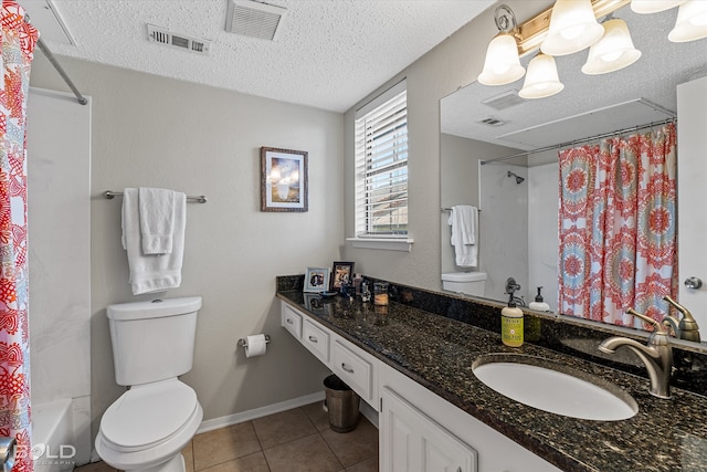 full bathroom with shower / bath combination with curtain, vanity, a textured ceiling, tile patterned floors, and toilet