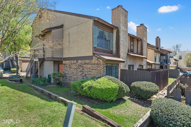 view of side of property with a lawn