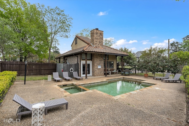 view of swimming pool featuring an in ground hot tub and a patio