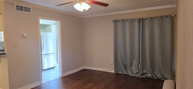 spare room featuring wood-type flooring, crown molding, a textured ceiling, and ceiling fan