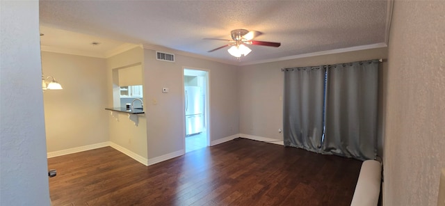 unfurnished room with ceiling fan, sink, a textured ceiling, crown molding, and dark hardwood / wood-style flooring