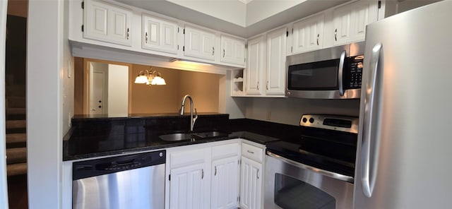 kitchen with white cabinets, appliances with stainless steel finishes, and sink