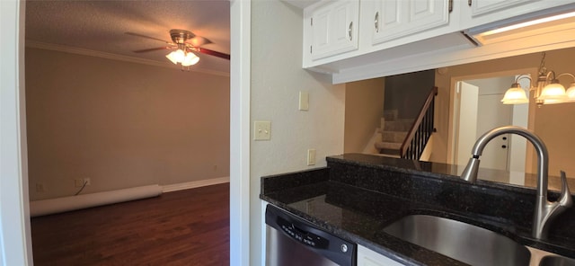 kitchen featuring stainless steel dishwasher, dark stone countertops, dark wood-type flooring, sink, and white cabinetry