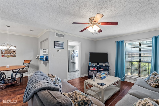 living room with a textured ceiling, dark hardwood / wood-style floors, and ornamental molding