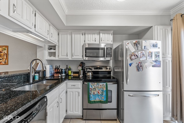 kitchen featuring white cabinets, appliances with stainless steel finishes, sink, and a textured ceiling