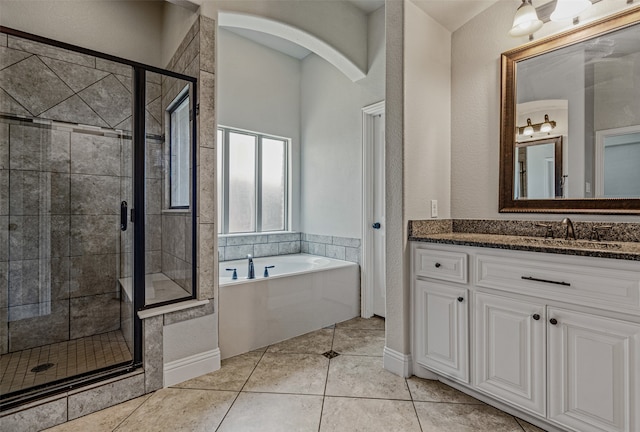 bathroom with vanity, plus walk in shower, and tile patterned flooring