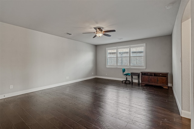 unfurnished room with dark hardwood / wood-style flooring and ceiling fan