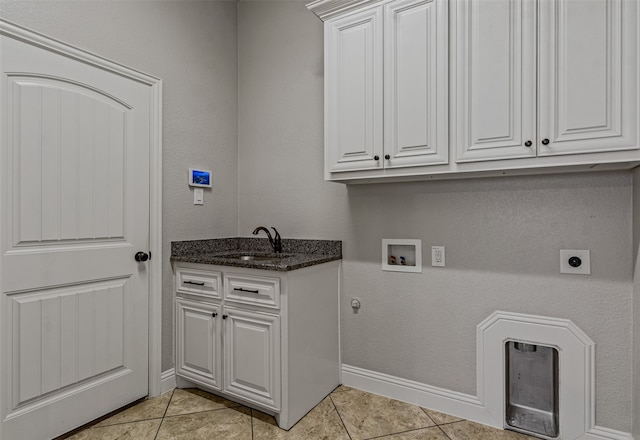 laundry area featuring cabinets, washer hookup, light tile patterned flooring, and sink