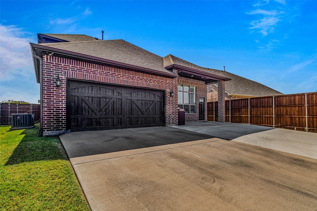 exterior space featuring a garage and cooling unit