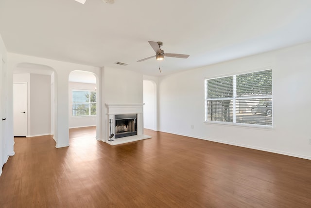 unfurnished living room featuring ceiling fan and dark hardwood / wood-style floors