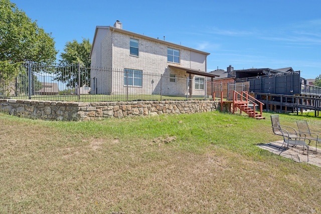 rear view of house with a yard