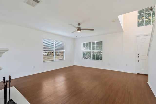 unfurnished living room with ceiling fan and dark hardwood / wood-style flooring