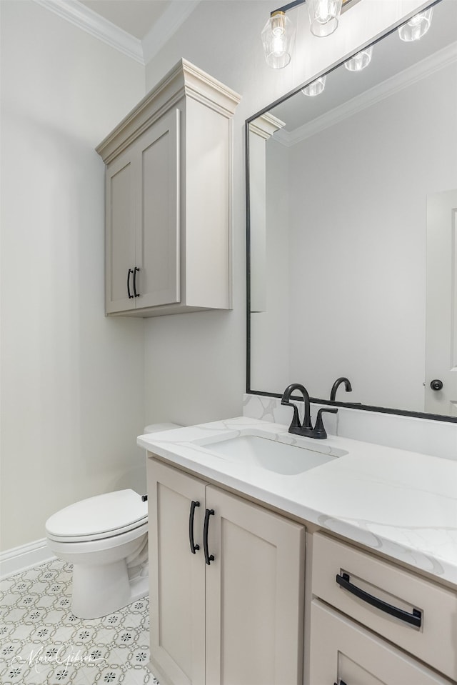 bathroom with vanity, toilet, and ornamental molding