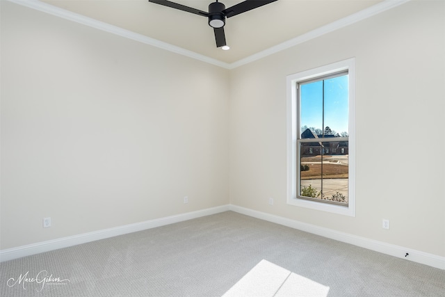 unfurnished room featuring carpet flooring, a wealth of natural light, crown molding, and ceiling fan