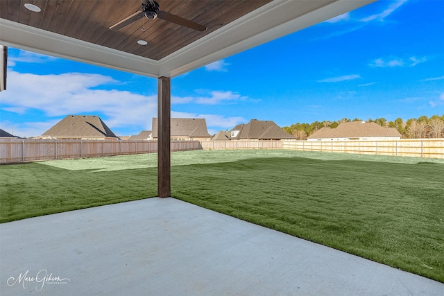 view of yard featuring a patio area and ceiling fan