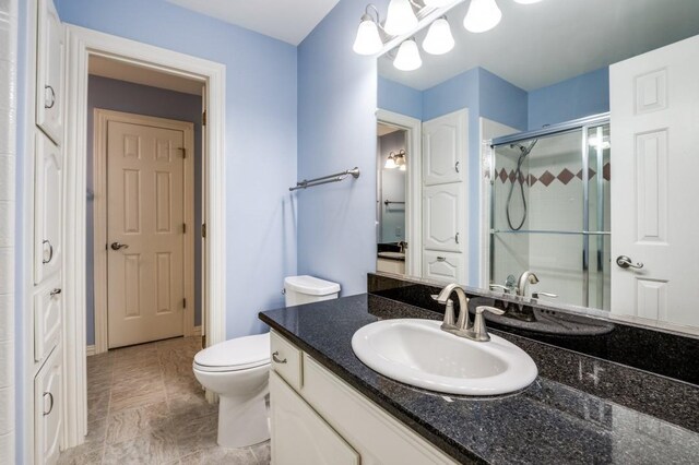 bathroom with a shower with door, lofted ceiling, and vanity