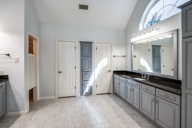 bathroom featuring vanity and vaulted ceiling