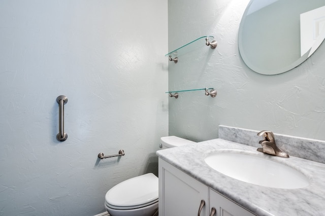 bathroom featuring toilet and vanity