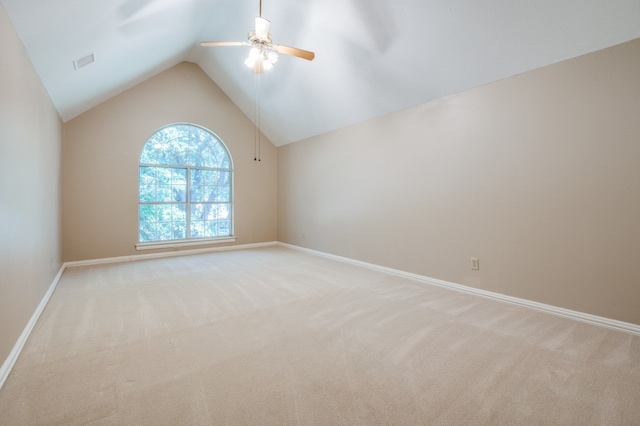 carpeted empty room with ceiling fan and vaulted ceiling