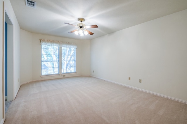 unfurnished room with ceiling fan and light carpet