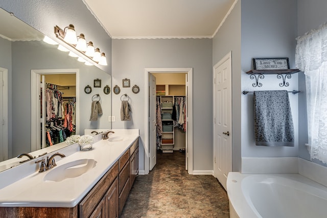 bathroom with vanity, a bathtub, and crown molding