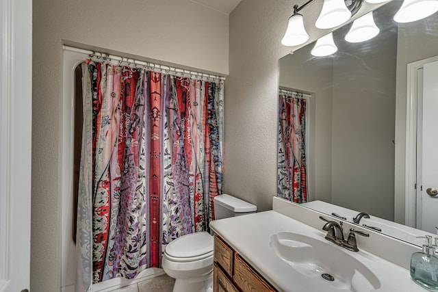 bathroom featuring tile patterned flooring, vanity, and toilet