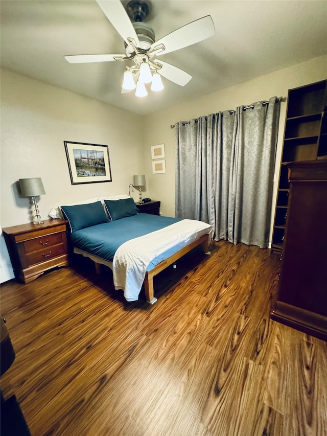 bedroom featuring dark hardwood / wood-style flooring and ceiling fan