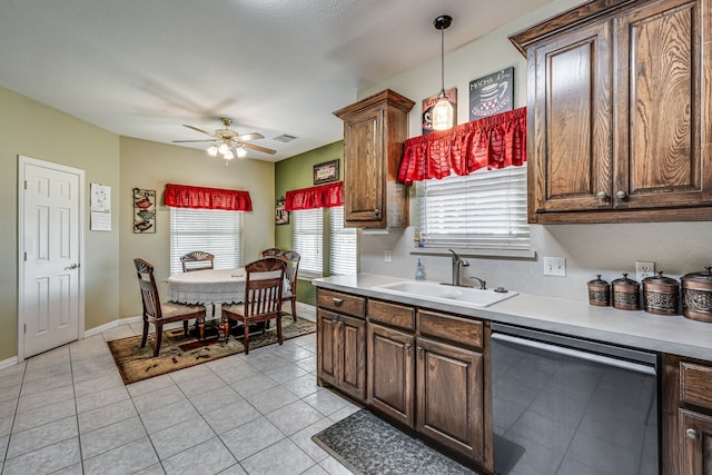 kitchen with ceiling fan, sink, dishwasher, hanging light fixtures, and light tile patterned flooring