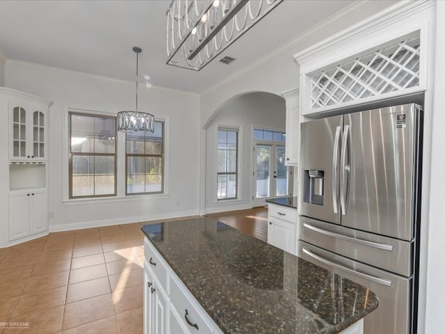 kitchen featuring ornamental molding, stainless steel fridge with ice dispenser, white cabinetry, and decorative light fixtures