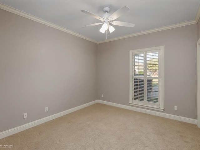 carpeted spare room featuring ceiling fan and crown molding