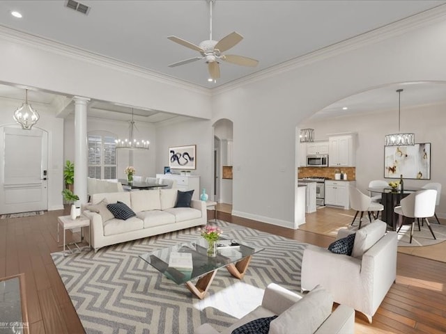 living room with crown molding, light wood-type flooring, and ceiling fan