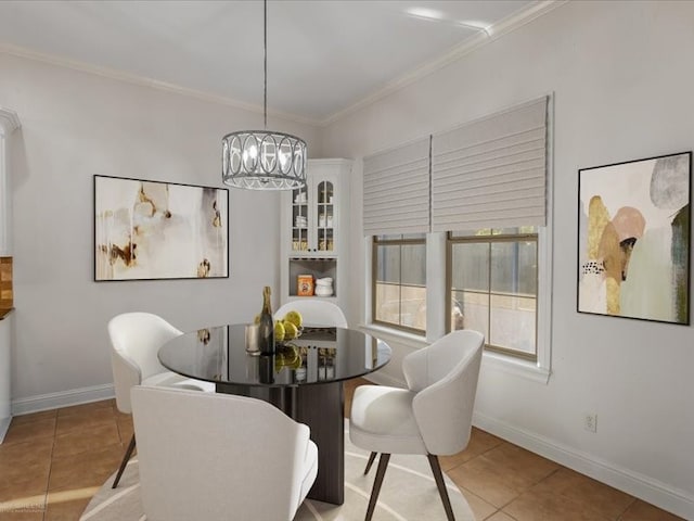 dining space with ornamental molding, an inviting chandelier, and light tile patterned floors